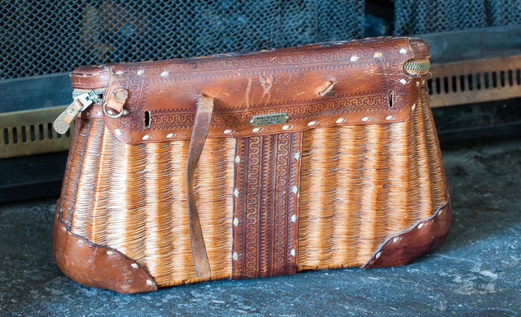 A HARDY WICKER FISHING CREEL with leather carrying straps and